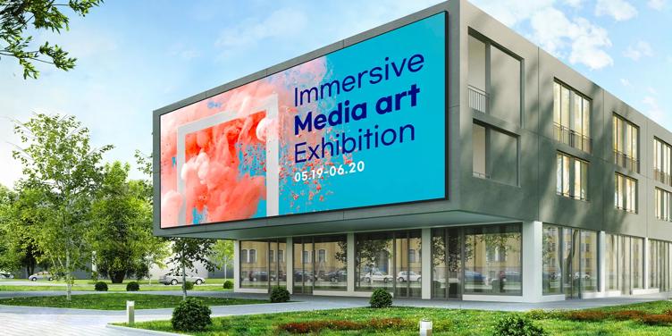 Modern building with a large billboard advertising an art exhibition.
