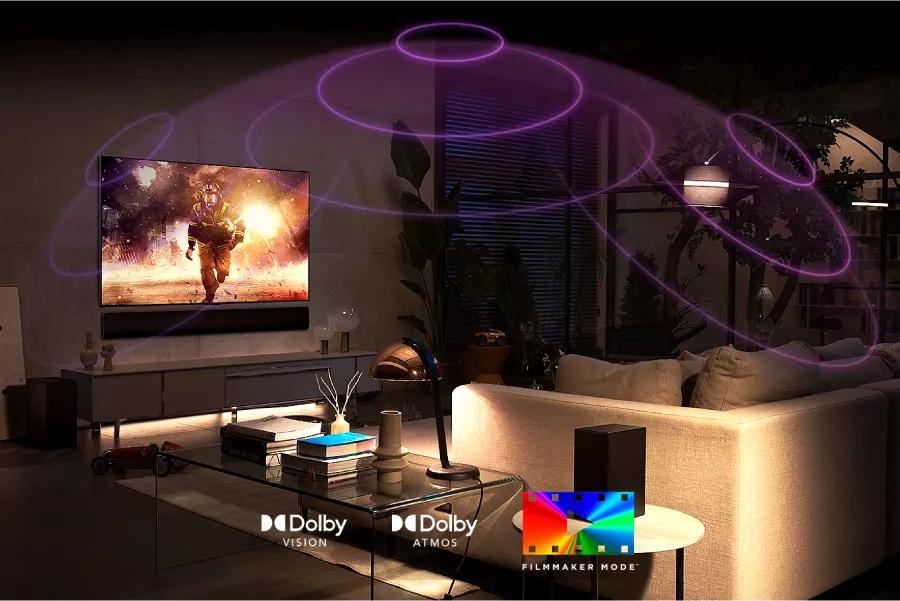 A movie plays on-screen with sound waves reverberating from the TV. Dolby Vision logo. Dolby Atmos logo. FILMMAKER MODE logo.