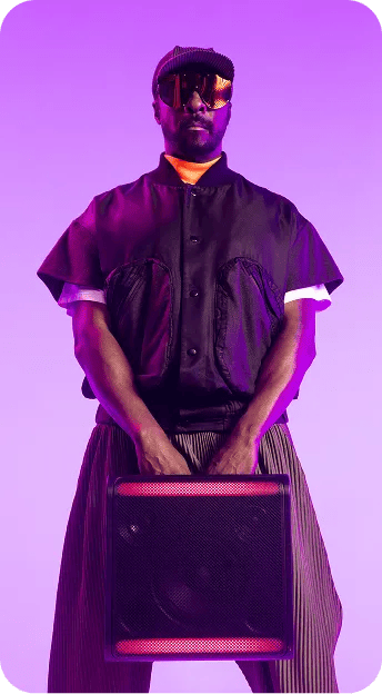 Will.i.am carrying an xboom speaker with both hands