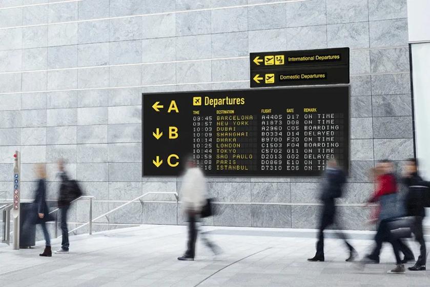 The first frame of the GIF shows travelers walking in front of an LG 105BM5P-B display in landscape mode, with arrival and departure information on its screen. The second frame shows the same display in an upscale mall setting, this time in portrait mode, advertising a new seasonal clothing collection.