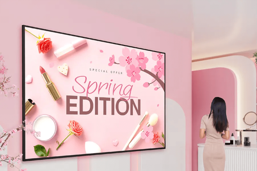 A promotional display for "Spring Edition" cosmetics in a pink-themed room.
