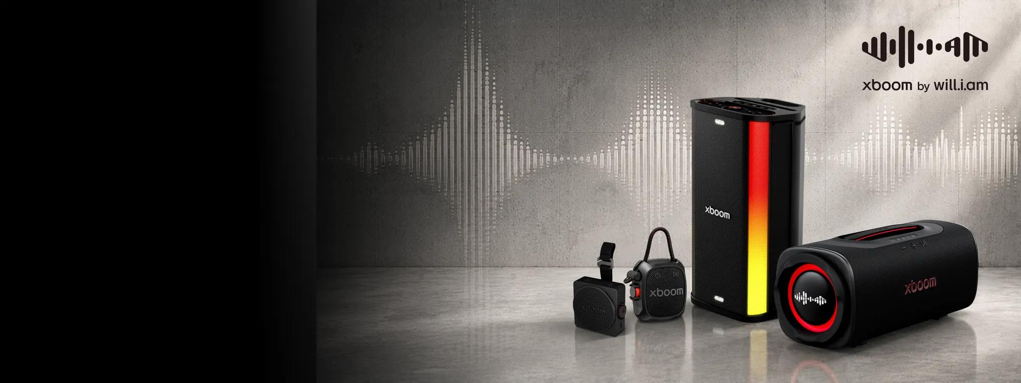 xboom by will.i.am -- LG xboom speaker lineup featuring a tall tower speaker with red and orange lighting, a compact wearable xboom speaker with strap, and a horizontal xboom speaker with red ring lighting, displayed against a concrete backdrop with a sound wave graphic