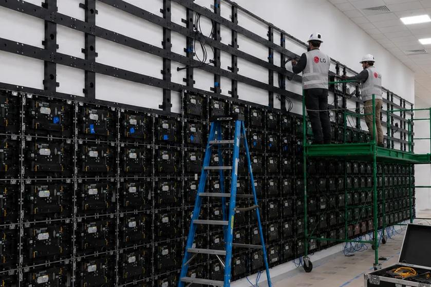 Workers install indoor LG Direct View LED panels