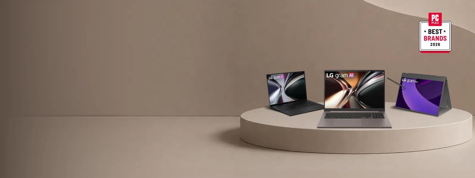 Three LG laptops—two LG gram AI models and one LG gram Pro 2-in-1 with a stylus—displayed on a neutral-toned pedestal alongside a PC Mag Best Brands 2026 badge