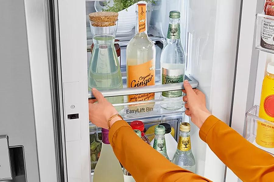 Refrigerator interior showcasing Adjustable Door In Door Bins