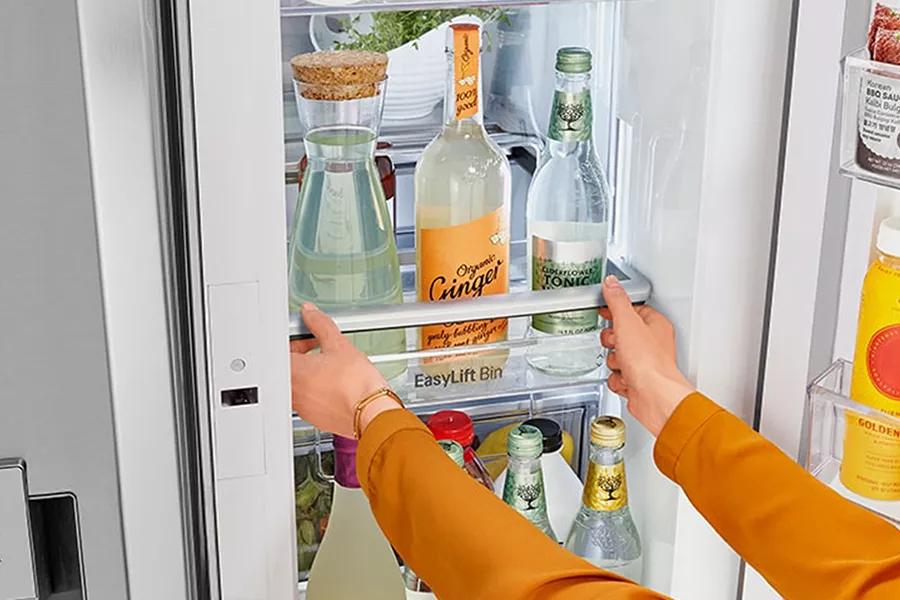 Refrigerator interior showcasing Adjustable Door In Door Bins