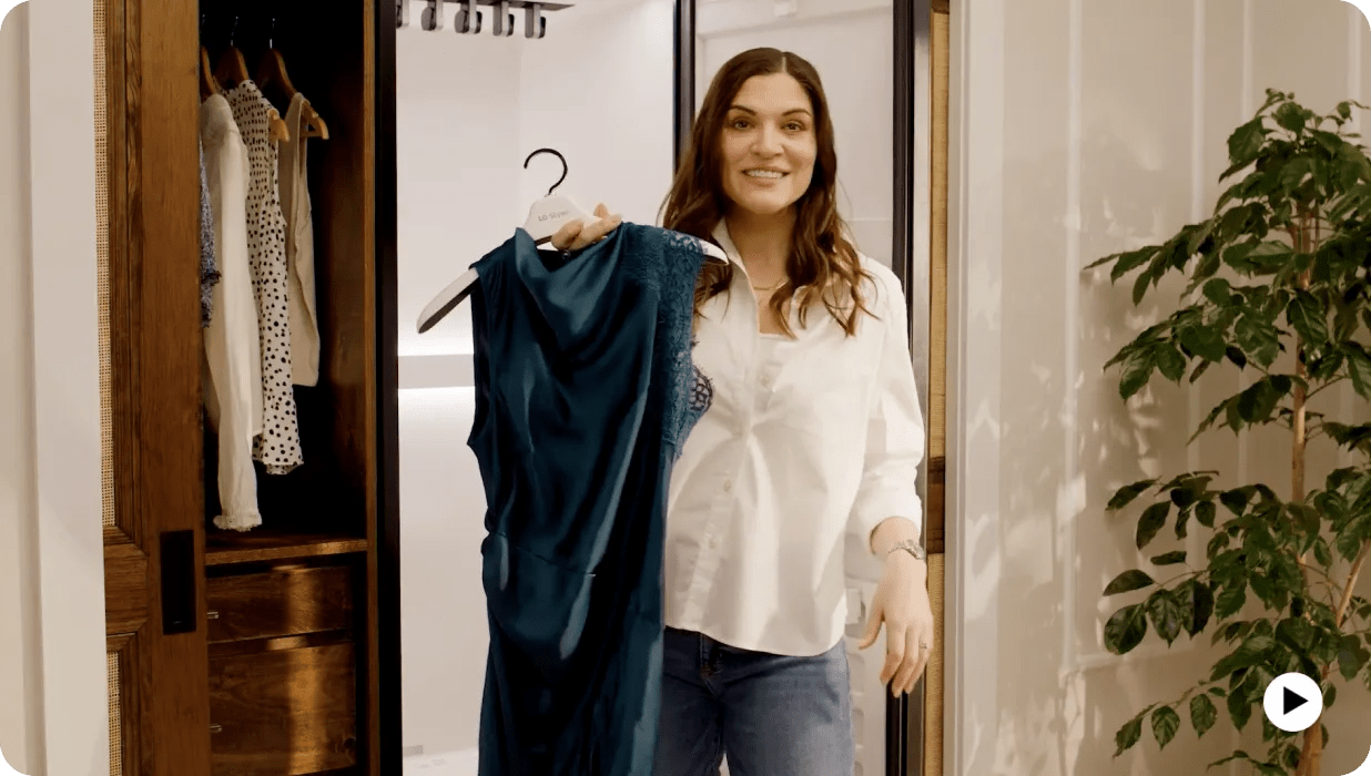 A screenshot from a video showcases a woman holding a green dress in front of an LG Styler®.