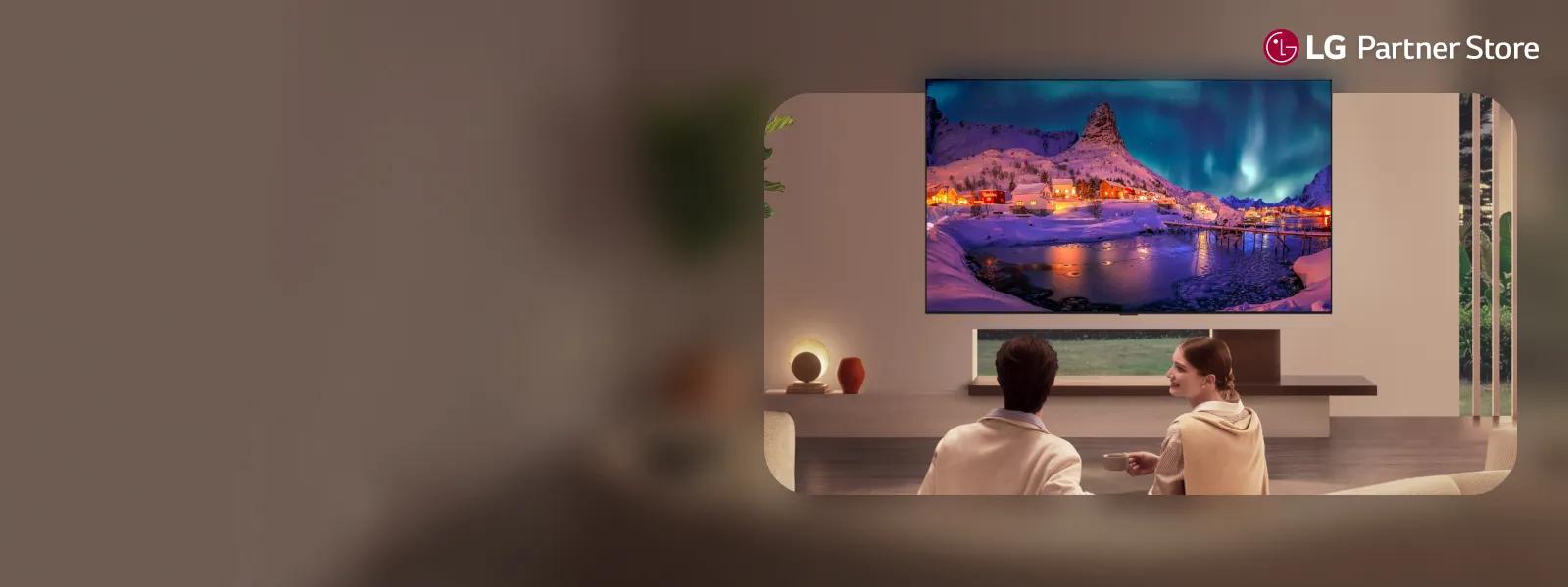 A woman chats with her friend in front of an LG fridge in a modern kitchen.