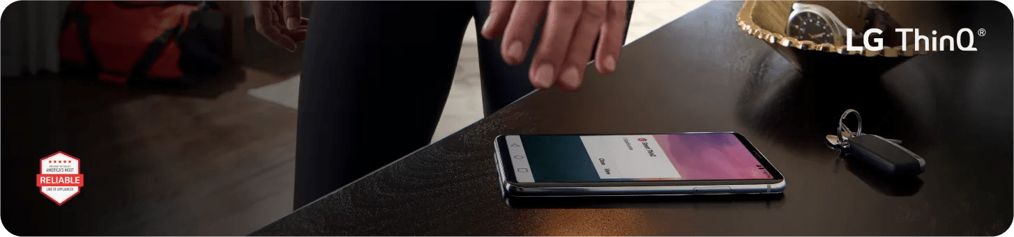 A smart phone on a table with a person ready to pick it up; A red hexagonal badge reads 'Brought to you by American's Most Reliable Line of Appliances' with five red stars at the bottom right.
