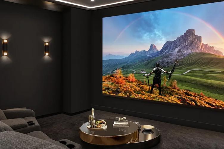A darkened home theater with an LG MAGNIT display, on which a fantasy movie scene is displayed.