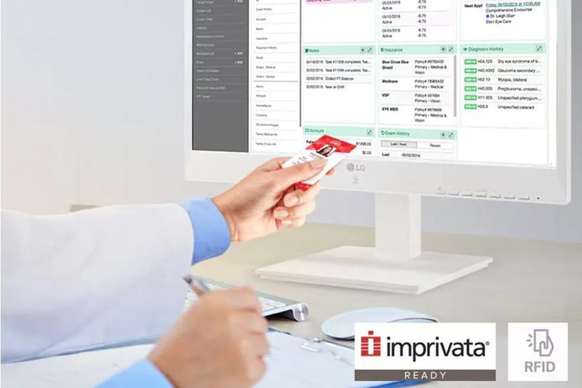 A medical professional holding their RFID card to an LG all-in-one cloud computing client for healthcare.