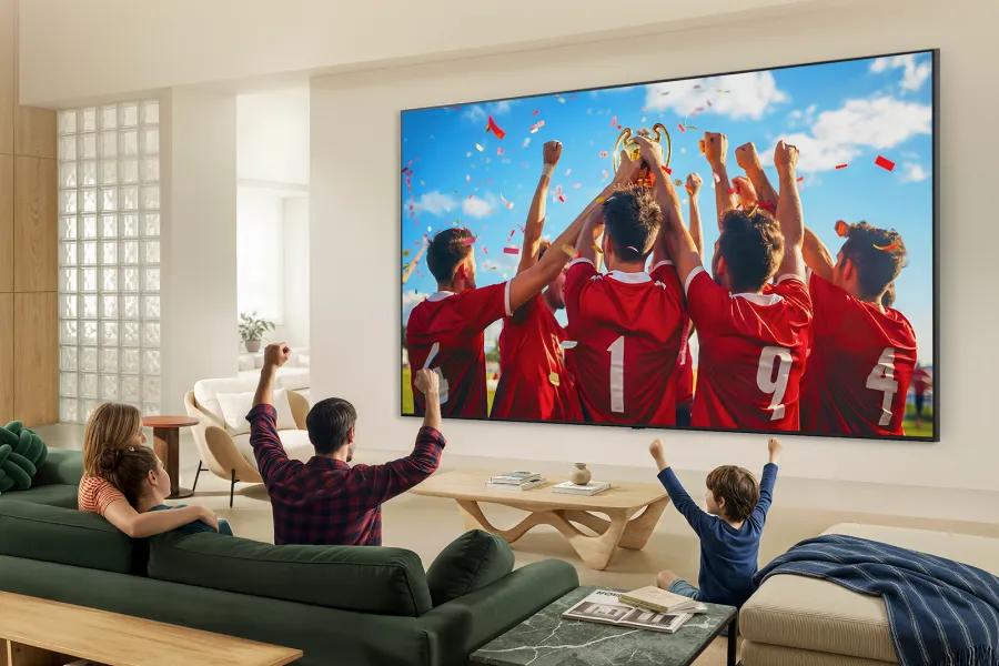 115QNED92BU LG QNED TV displaying vibrant sports celebration scene in modern living room with family watching