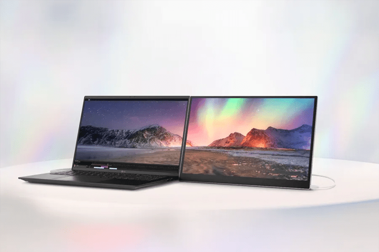 Two open laptops on a light surface, displaying colorful mountain landscapes.