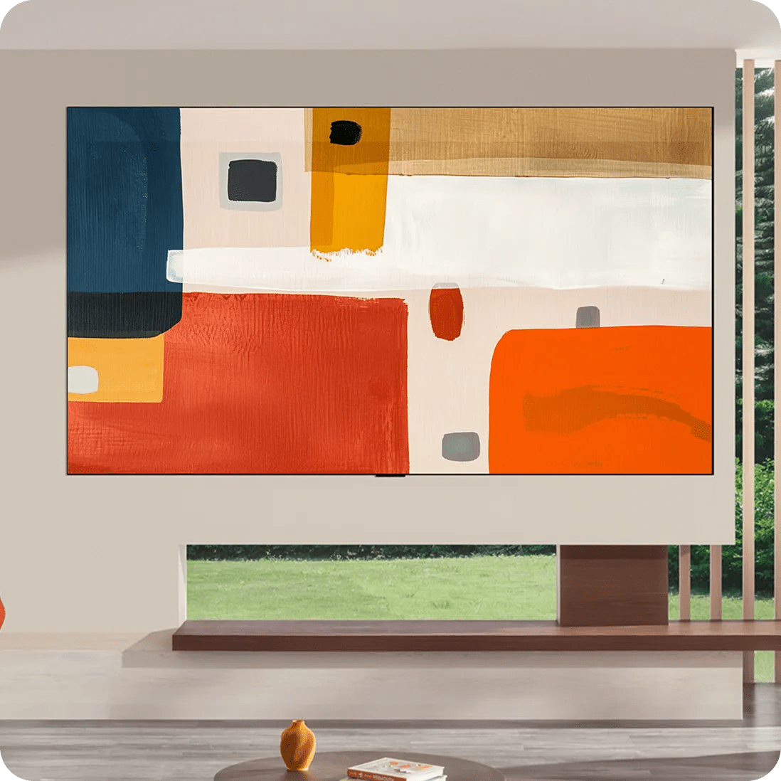 In a modern living space with expansive windows and clean architectural framing, the LG OLED evo G6 Gallery TV appears integrated into the wall, showcasing a large-scale abstract painting in layered neutrals, orange and blue.