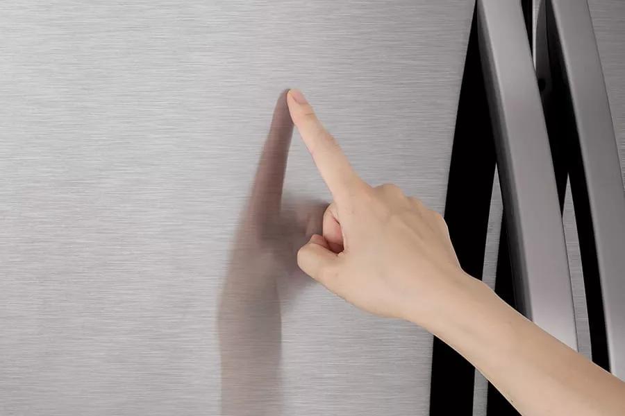 Hand touching refrigerator PrintProof finish