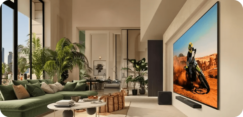 Bright modern living space with an LG TV displaying a dirt bike rider in an action scene.