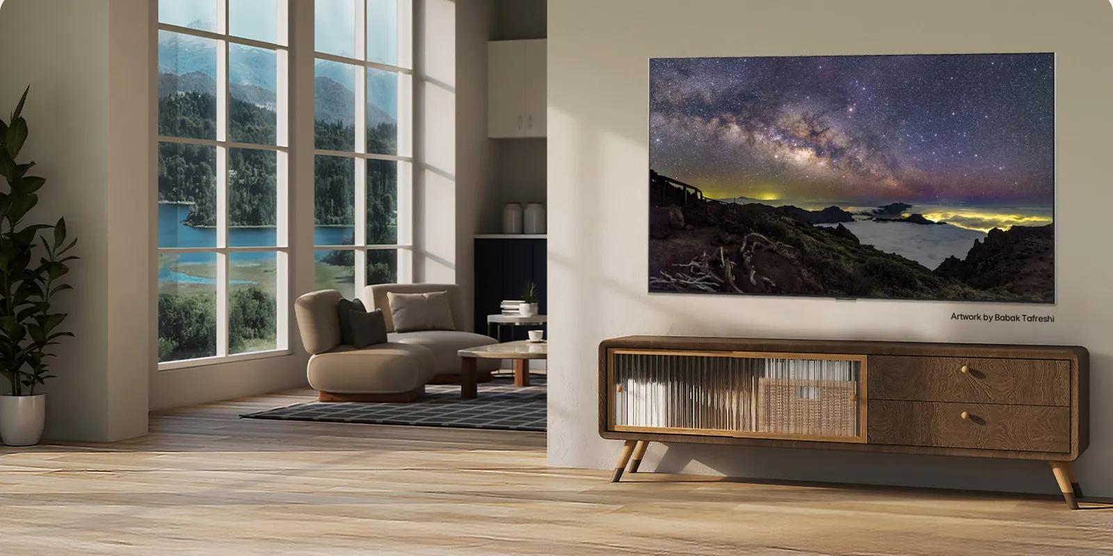 Interior of a countryside home. A huge wall-mounted LG TV is displaying a beautiful natural landscape artwork on its screen. The TV looks like a photograph hung on the wall. 