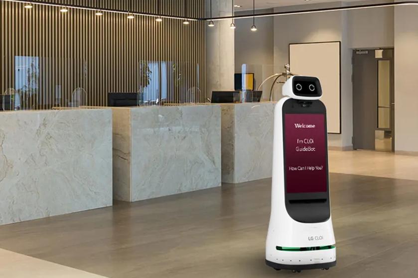 CLOi stands in the lobby of an elegant hotel. Her display welcomes guests and offers to assist them.