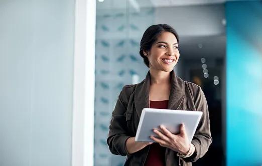 Shot of a woman using her digital tablet in a office