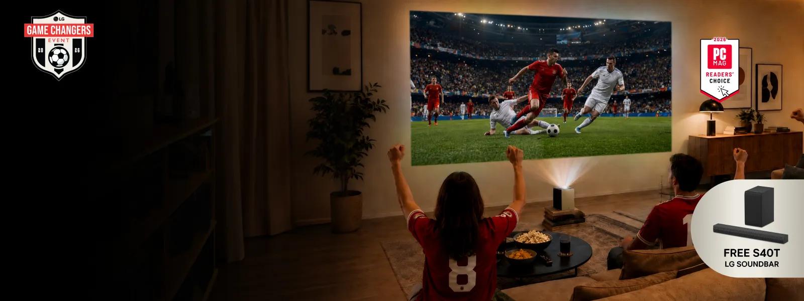A group of friends watch a soccer screen with an LG projector from a living room. “Game Changers Event 2026”, “FREE LG Soundbar” pop-out text. “2026 PC MAG Readers’ Choice” badge.