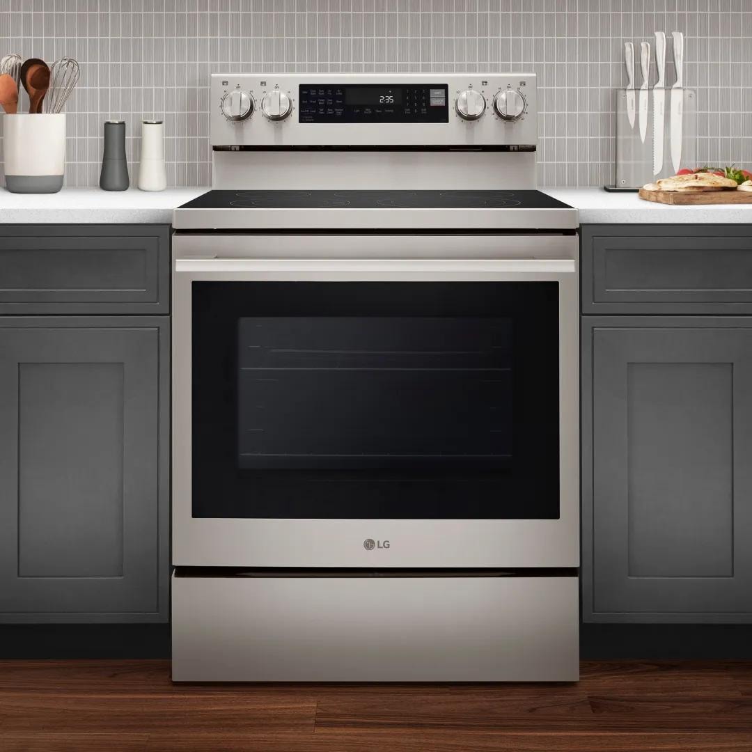 A stainless steel LG range in a modern kitchen with blue cabinetry.