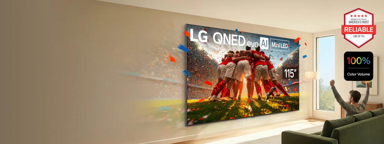 A massive 115” OLED displays a scene from a soccer match is a sunny living room as a man watching cheers. “100% Color Volume” badge. 