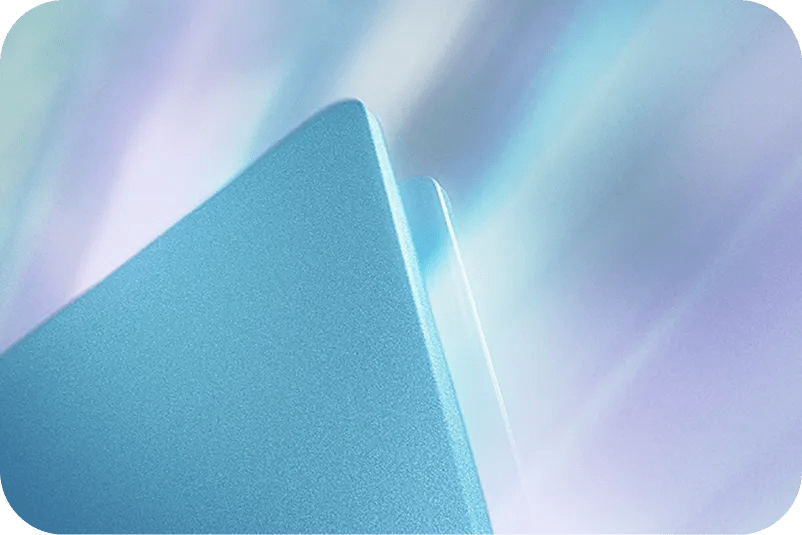 Close-up of sleek metallic LG gram edges in blue tones against a soft, blurred pastel background.