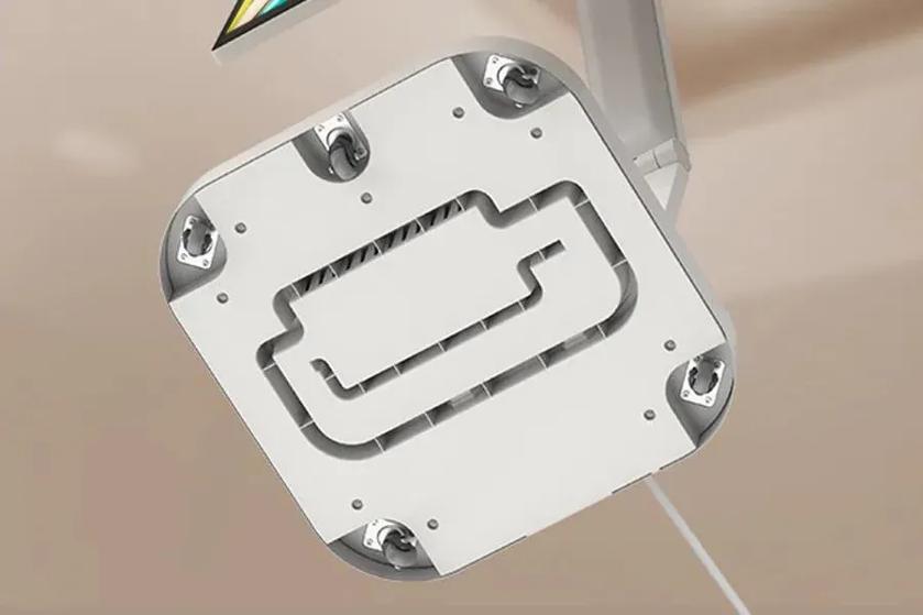 Underside view of a rolling monitor stand a white casing and wheels