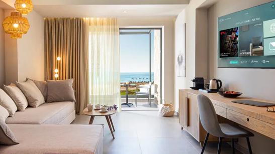 A modern hotel room with a balcony and an LG hospitality TV.