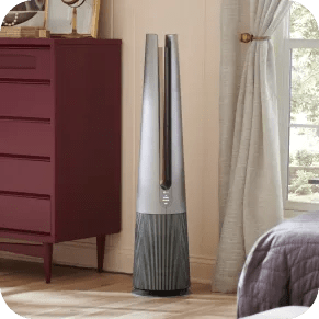 An LG air purifier sits in the corner of a modern, brightly lit living room.