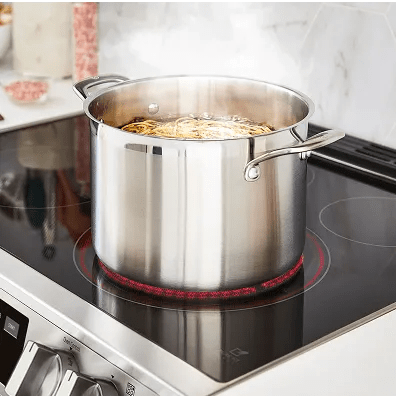 A pot of water boils on an electric stovetop.