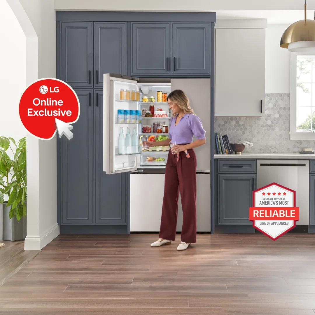 Woman in a purple top reaching into a built-in stainless steel LG bottom-freezer refrigerator stocked with drinks and produce, in a kitchen with navy cabinetry and hexagon tile backsplash. An "LG Online Exclusive" badge appears on the left, with an "America's Most Reliable Line of Appliances" badge on the right.