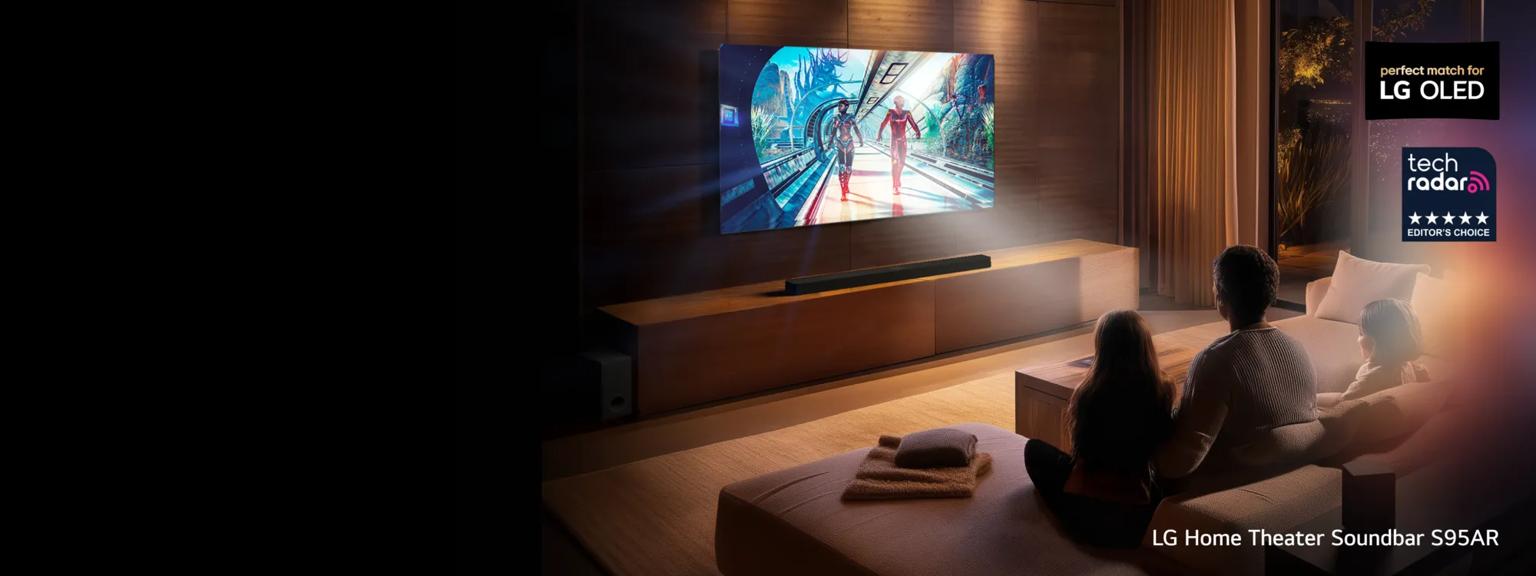An LG TV  equipped with a matching soundbar displays a movie scene as a man, woman and child look on. “Perfect match for LG OLED” and “Tech Radar Editor’s Choice” badges. Text below reads “LG Home Theater Soundbar S95AR”.