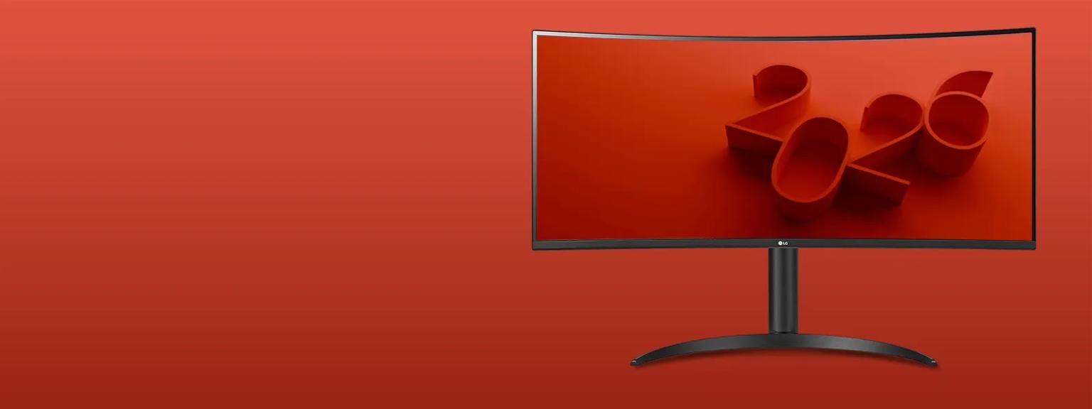LG UltraWide monitor on a red background, with the screen displaying sleek red 3d text '2026'