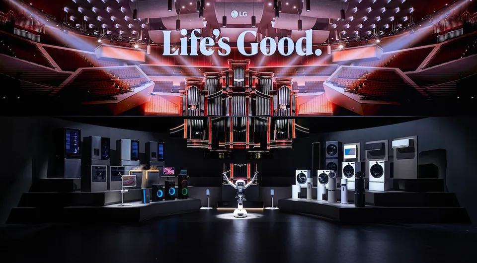 LG IFA 2026 event showcase displaying a wide range of LG home appliances, audio products, and a robot on a stage beneath a large screen reading "Life's Good." with the LG logo above, set inside a grand auditorium venue.