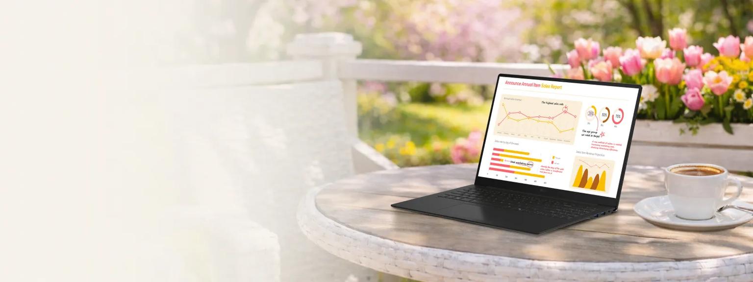 An LG gram Laptop sits open on a white outdoor café table beside a cup of coffee, displaying a colorful analytics dashboard with charts and graphs. Pink tulips bloom in the background, creating a bright spring setting.