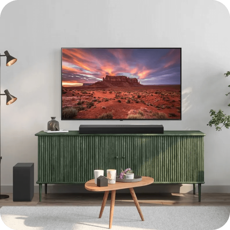 LG TV setup with soundbar and wireless subwoofer in a green-themed media room.