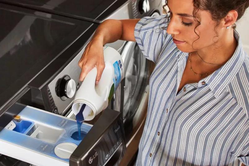 Washer showcasing open detergent and fabric softener dispenser