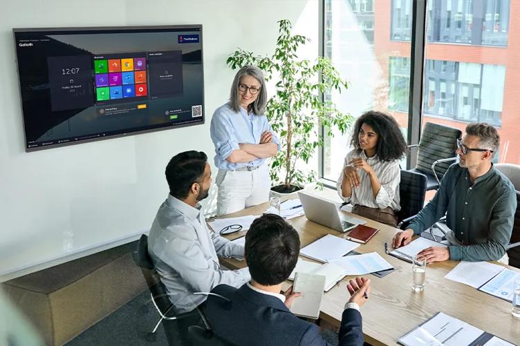 Team meeting with LG CreateBoard on the conference room wall.