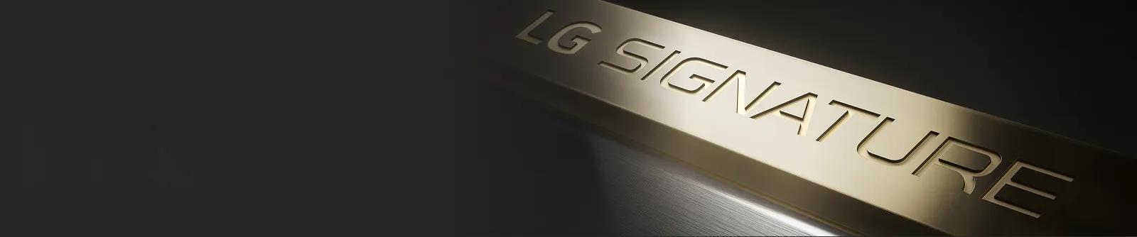 LG SIGNATURE embossed brass logo in brushed metal finish, close-up view.