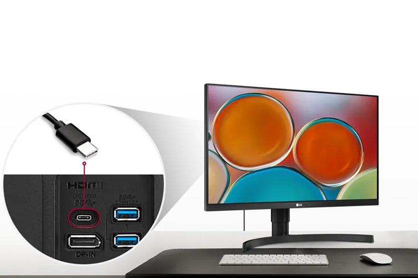 A computer monitor displaying colorful circles, with an inset showing its connection ports and a USB-C cable.