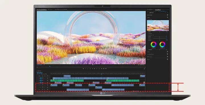 An LG gram laptop sits open, facing the viewer. There is an editing software open on the screen. The image being edited is of an iridescent bubble in a luscious field of multicolored flowers.