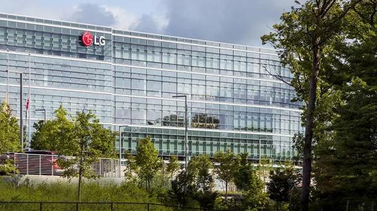 An outdoor view of the LG building in Los Angeles, framed by the green grass and trees in the foreground.