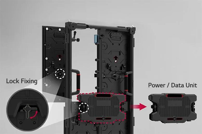 The image depicts a detailed view of a locking mechanism and a power/data unit on an industrial panel. The panel is vertically oriented with a dark finish, featuring a series of geometric patterns and fasteners on its surface. On the left side, there is a circular magnified inset showing the lock fixing, with an arrow indicating the locking direction. To the right, a rectangular power/data unit is highlighted in red, suggesting its removable or attachable nature to the main panel, depicted by an arrow pointing toward the panel. The background is a neutral gray, allowing the black panel and components to stand out clearly.