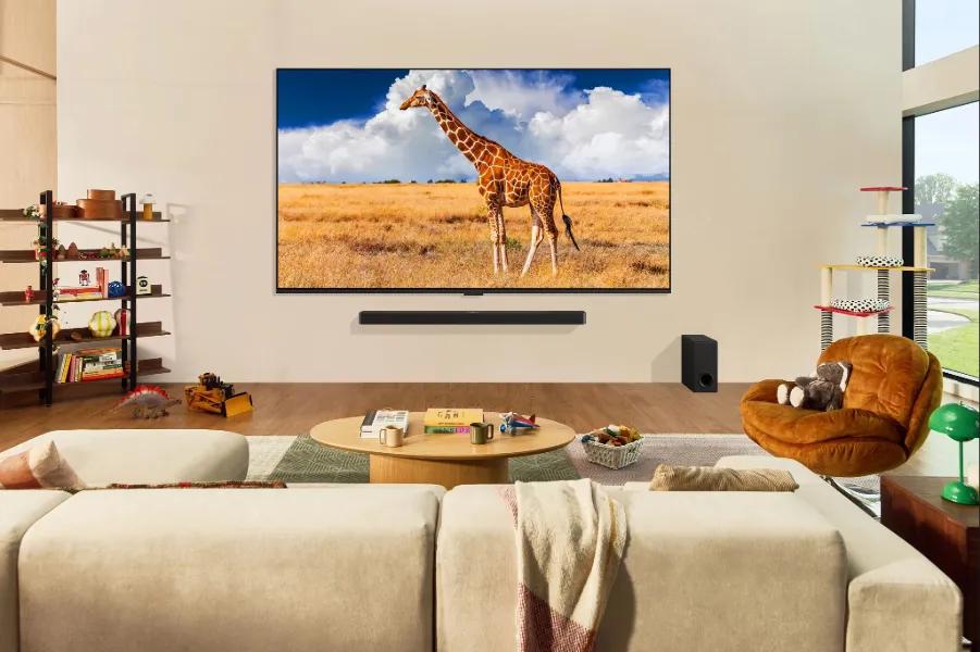 65-Inch LG QNED 4K TV 65QNED84BUA wall mounted in modern living room with soundbar and subwoofer