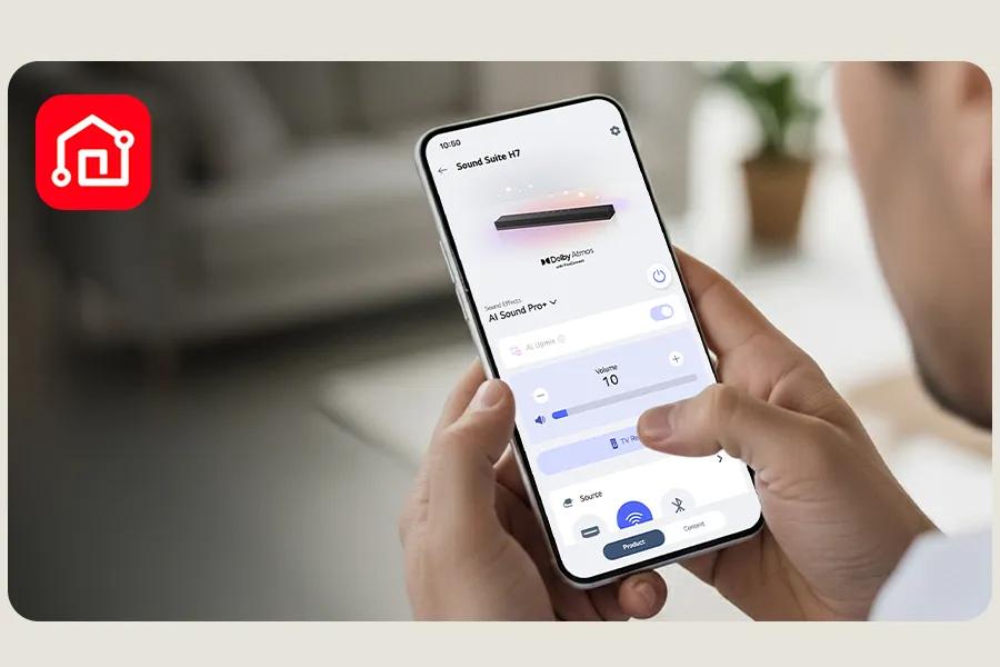 Image of a person holding a mobile phone with the LG ThinQ open and connecting to an LG Sound Suite product