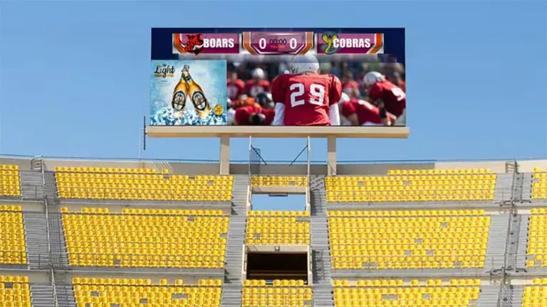 A large LG outdoor display shows a football game over stadium stands. 