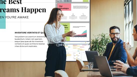 Group of professionals in a meeting room with LG signage and laptops.