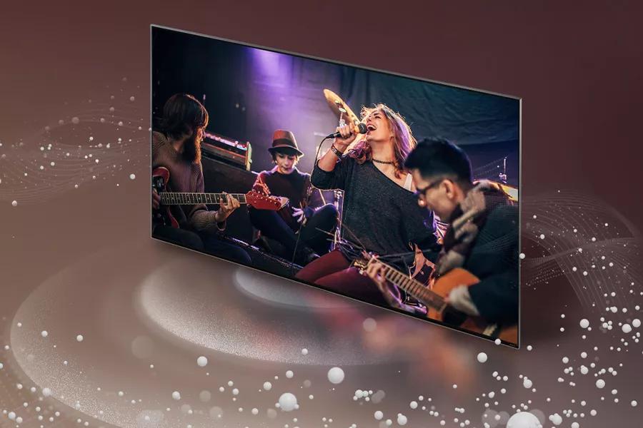 Sound waves emanate from all around an LG UT7590 with the screen featuring a band performing.