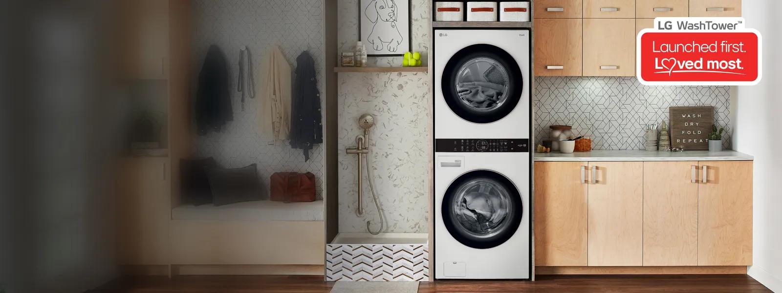 A wide banner showing a beautifully organized mudroom and laundry space featuring a white LG WashTower stacked unit, light wood cabinetry, and a dog washing station, with an promotional badge reading 'LG WashTower: Launched first. Loved most.'
